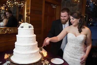 Stroudsmoor Country Inn - Stroudsburg - Poconos - Real Weddings - Bride And Groom Cutting Into The Cake