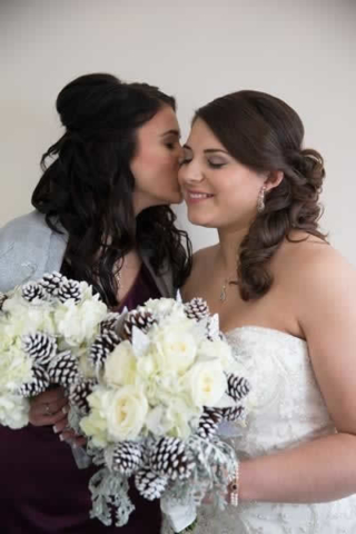 Stroudsmoor Country Inn - Stroudsburg - Poconos - Real Weddings - Bride Getting A Kiss From Bridesmaid