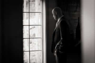 Stroudsmoor Country Inn - Stroudsburg - Poconos - Real Weddings - Groom Gazing Out Of Window