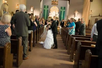 Stroudsmoor Country Inn - Stroudsburg - Poconos - Real Weddings - Bride And Groom Kissing In Chapel