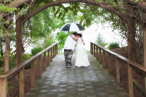 Stroudsmoor Country Inn - Stroudsburg - Poconos - Real Weddings - Happy Married Couple Under Outdoor Trellis