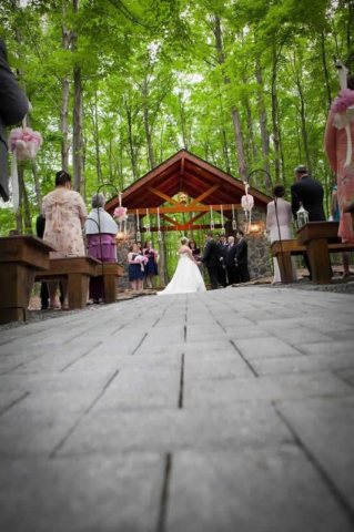 Stroudsmoor Country Inn - Stroudsburg - Poconos - Woodlands Outdoor Wedding - Wedding Couple Under Alter With Guests