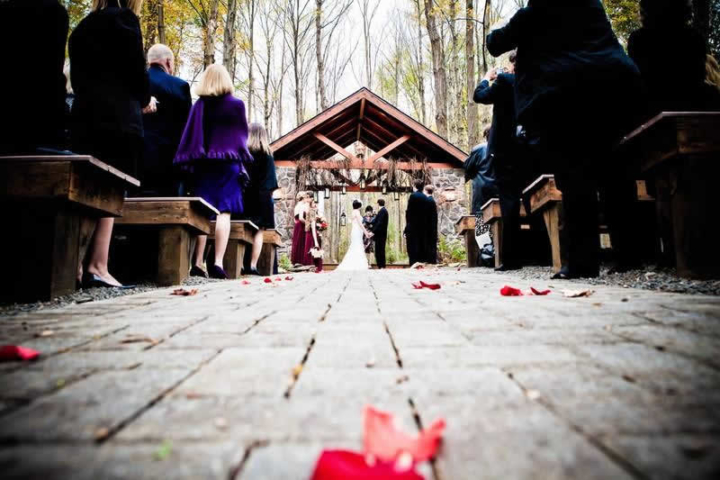 Stroudsmoor Country Inn - Stroudsburg - Poconos - Woodlands Outdoor Wedding - Wedding Couple Under Outdoor Chapel Joined By Wedding Party