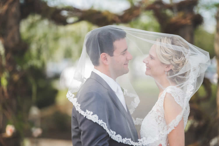 Wedding couple kissing under the veil