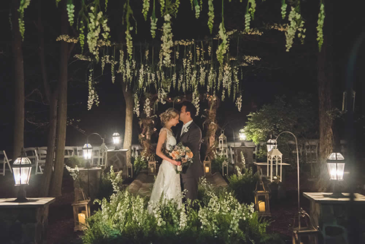 Wedding couple posing, groom kissing bride on forehead