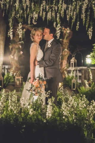 Wedding couple posing, groom kissing bride on cheek