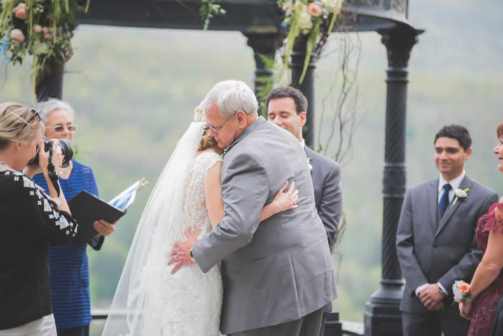 Bride hugging her father at ceremony