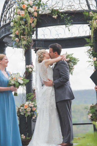 Bride and groom kissing at ceremony