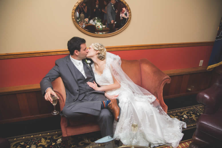 wedding couple kissing on a love seat