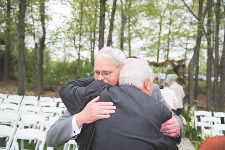 Men hugging during wedding