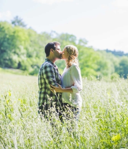 Real Pocono Weddings - Stroudsmoor Country Inn - Poconos Pennsylvania - Couple kissing in a field