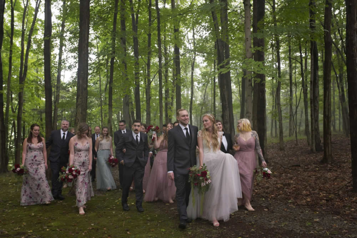 wedding event A wedding party walks through the forest