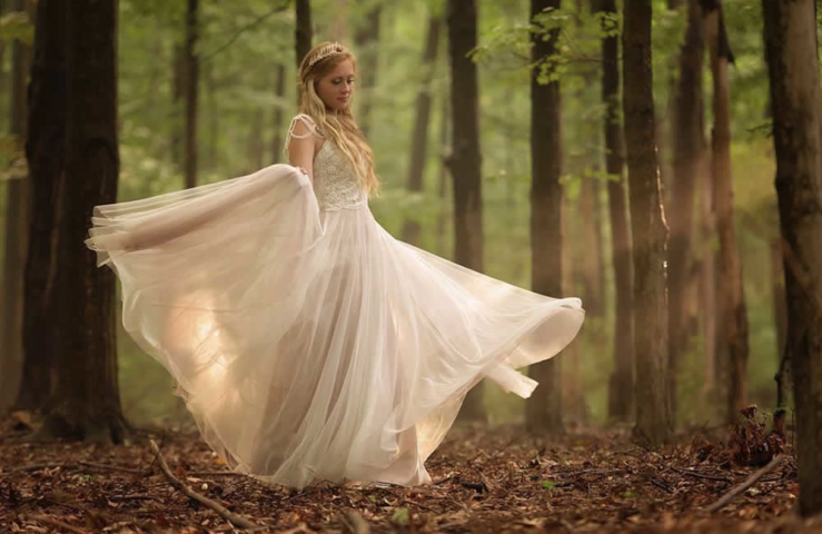 Bride twirling wedding dress in the woods Bride twirling wedding dress in the woods