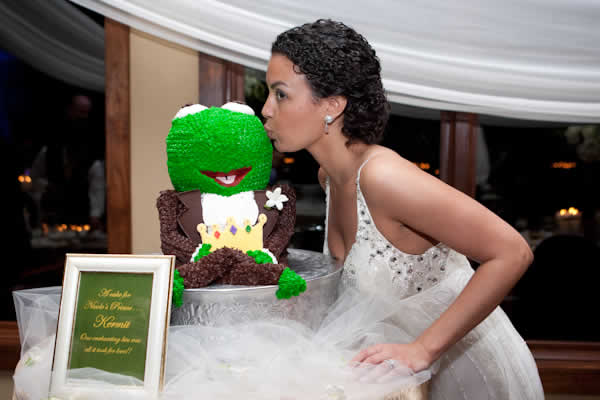 Bride kissing Kermit the Frog cake.