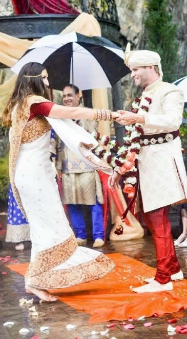 The bride danced barefoot as the groom spun her around.