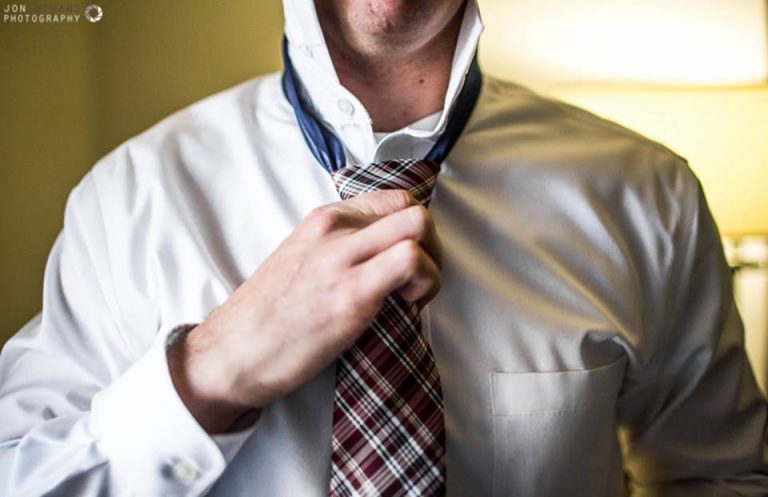 Man adjusting his tie