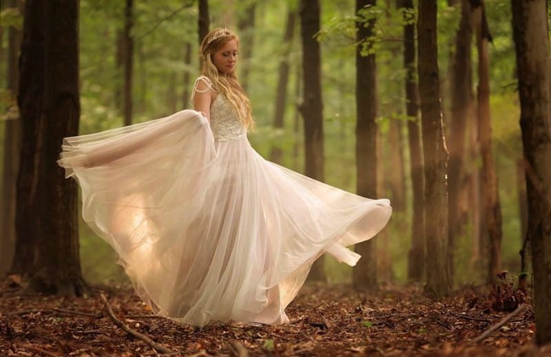 Bride walking through the forest