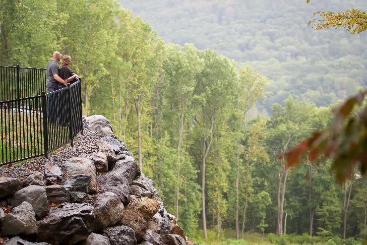 Couple on balcony overlooking mountains