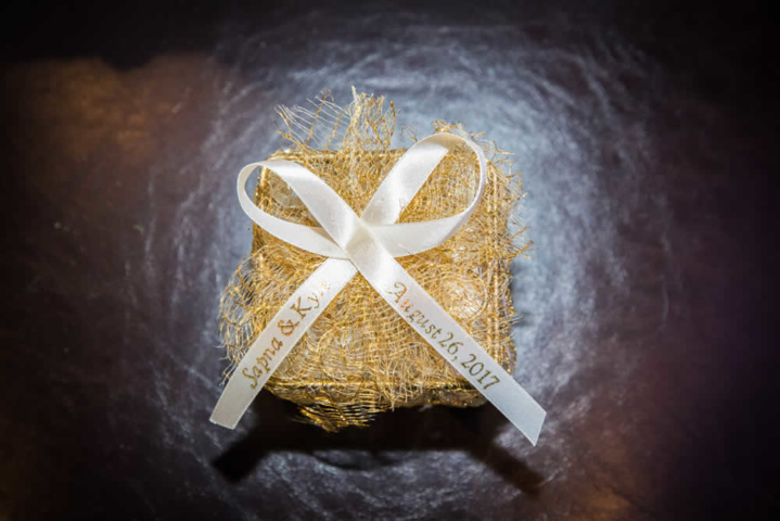 Golden wedding gift with white ribbon