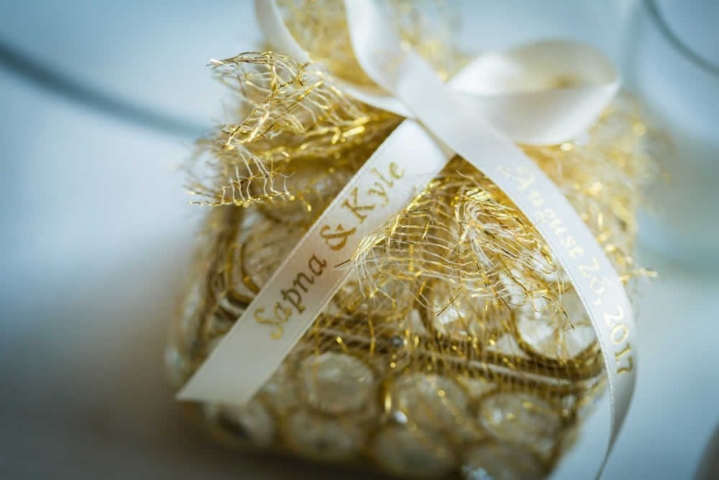 Golden wedding gift with white ribbon
