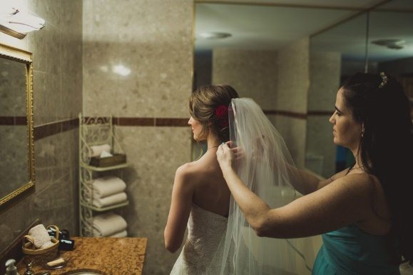 Bride fixing her veil