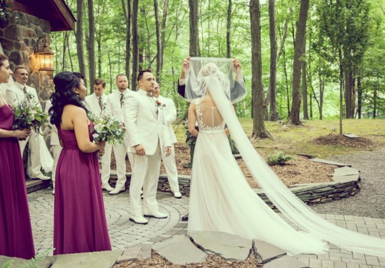 Groom lifting the veil