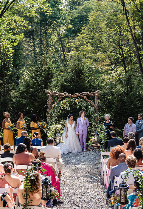 Bride and groom hold hands at Pavilion ceremony site