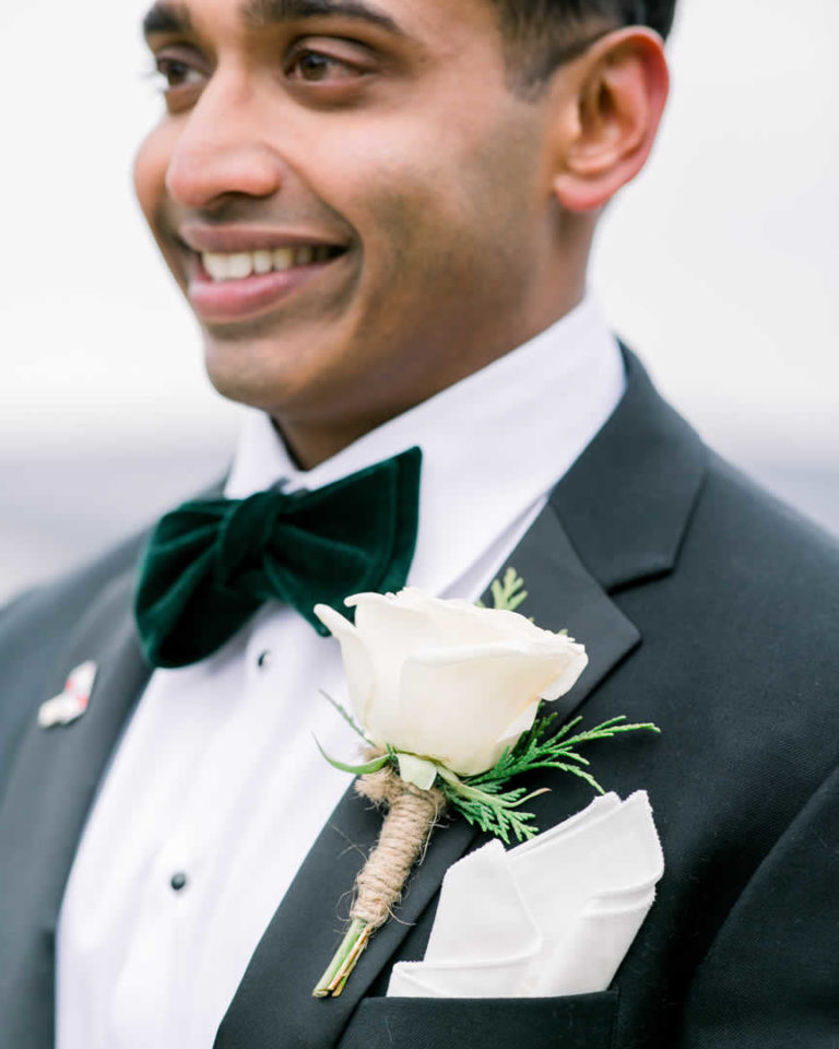 White boutonniere on grooms suit