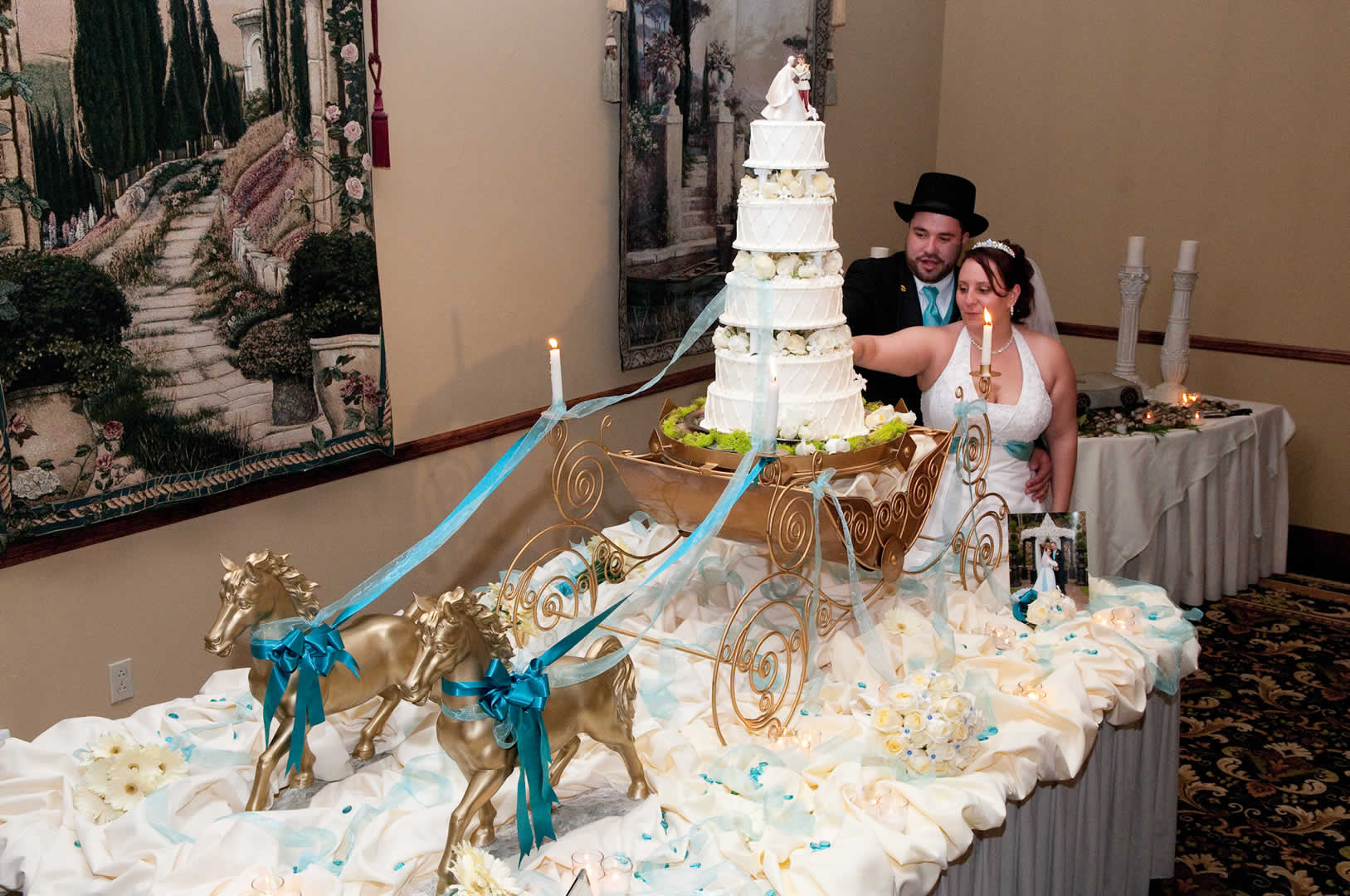 Wedding couple cutting four layer wedding cake terraview