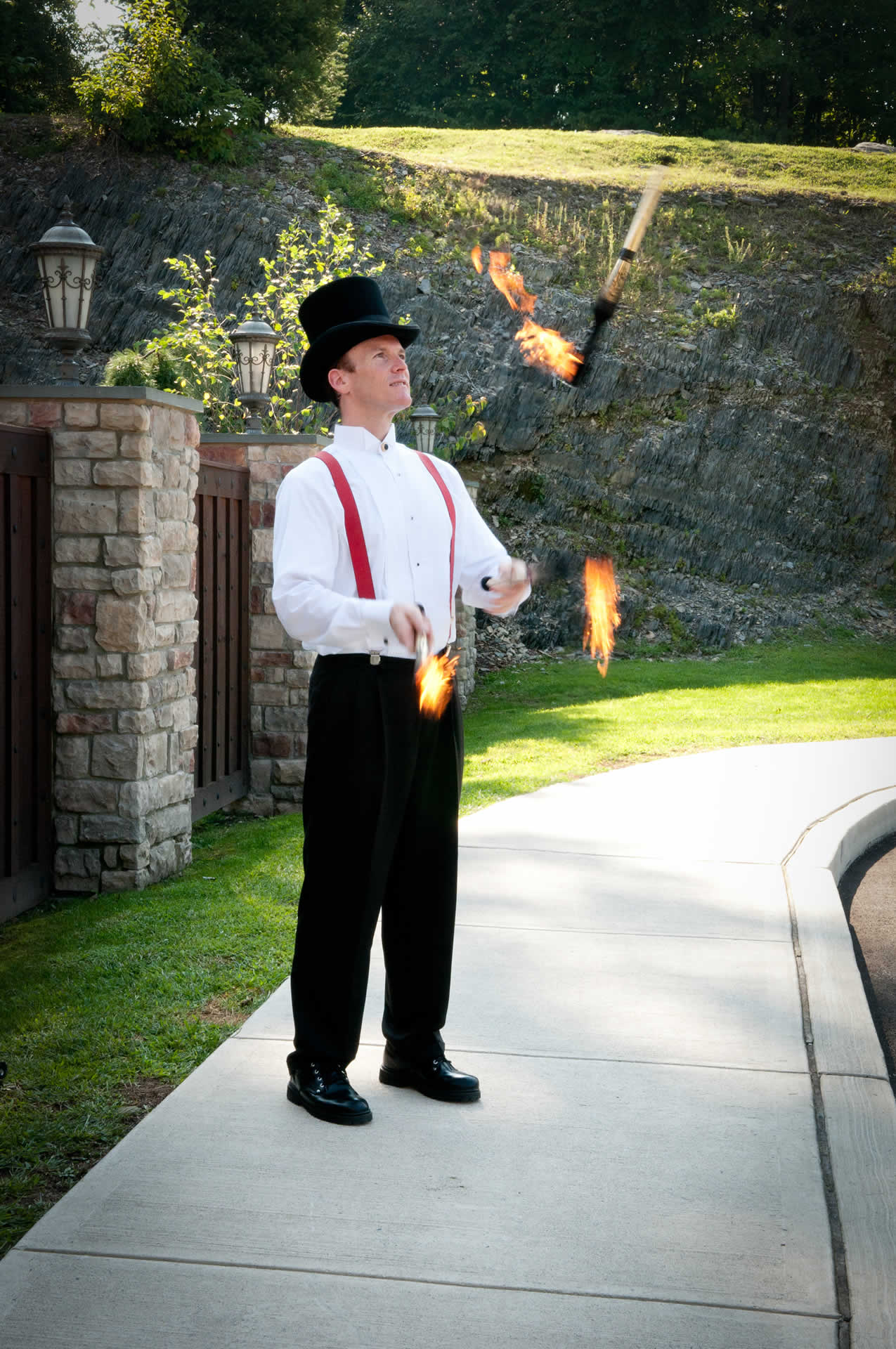 Man juggling sticks on fire terraview