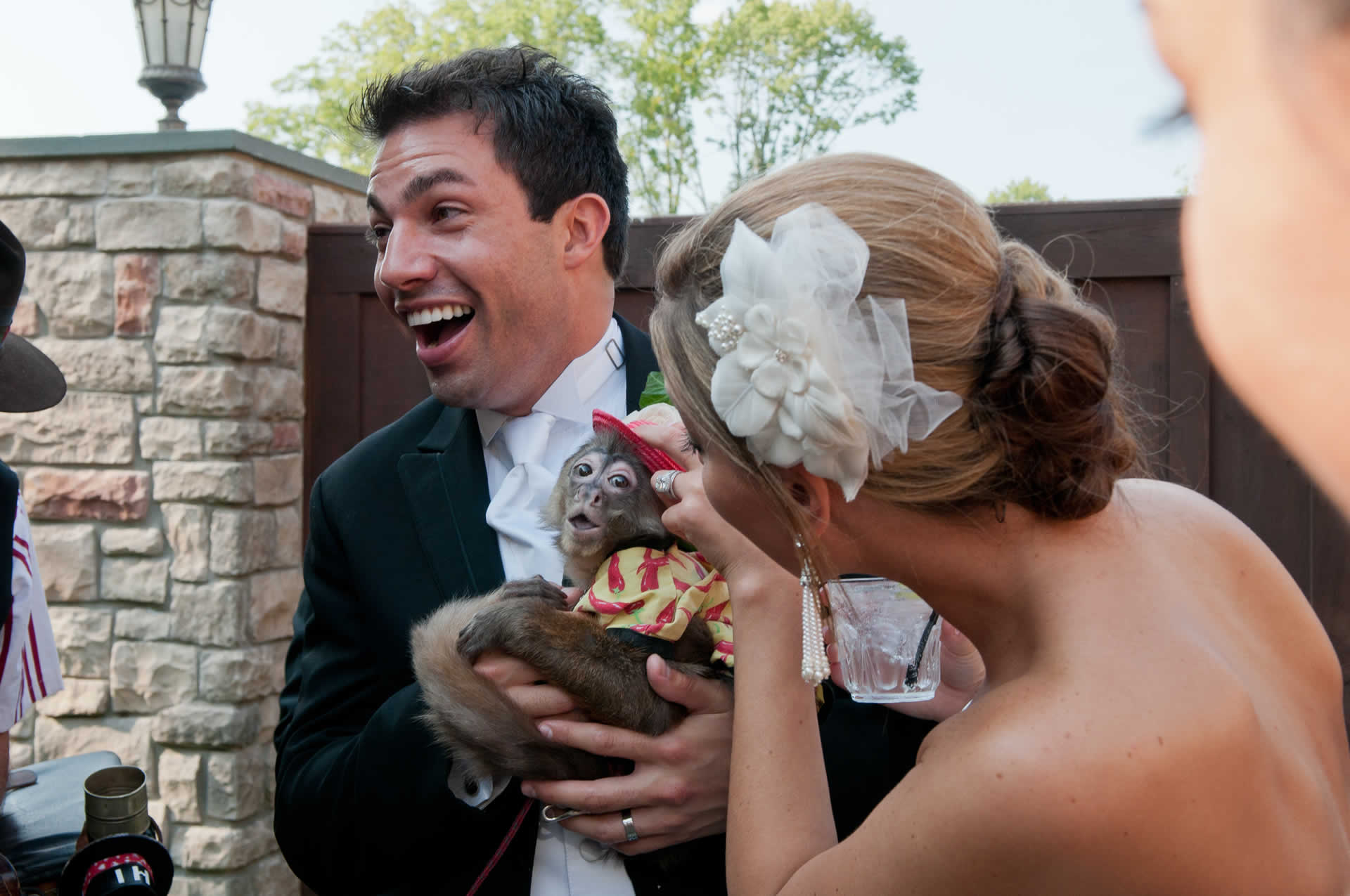 Wedding couple holding a monkey