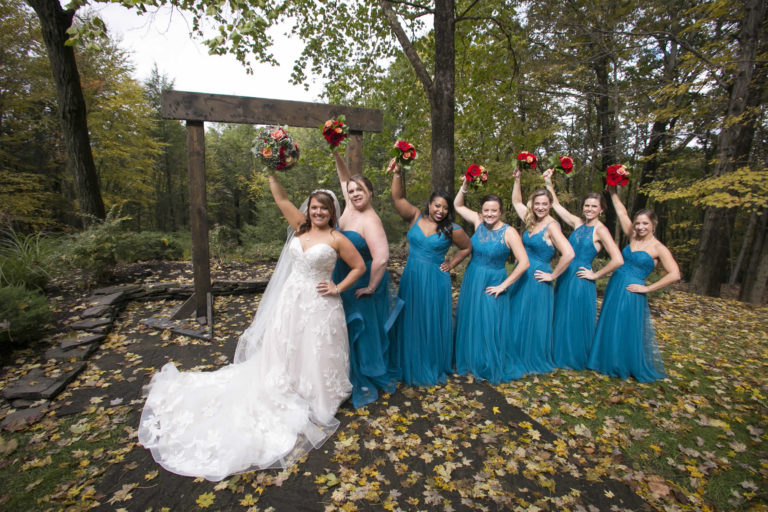 Bride and bridesmaids holding up flower bouquet lawnhaven