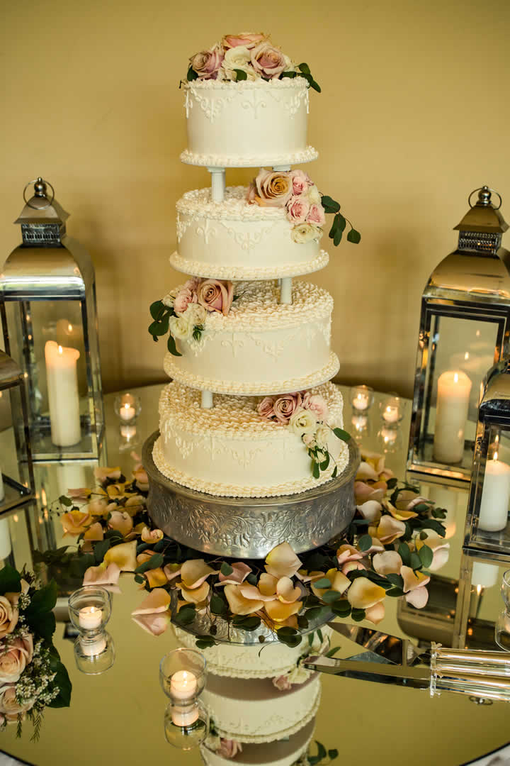 Four layered wedding cake floral and decor terraview