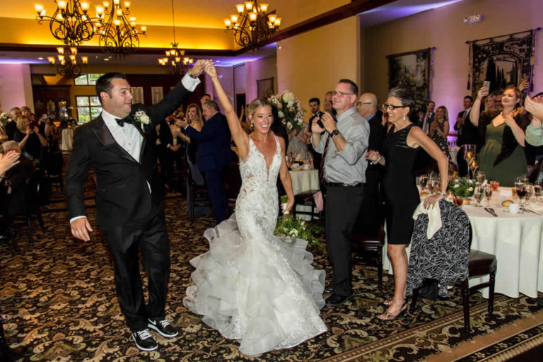 Bride and groom walking out as married couple terraview