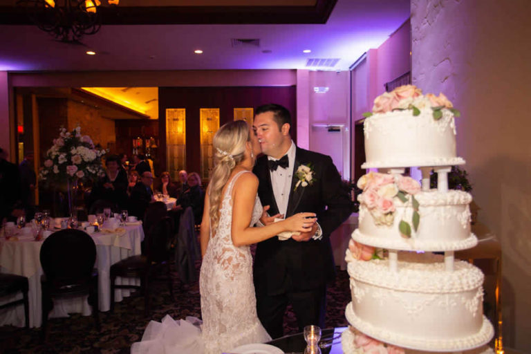 Wedding couple kissing with icing on faces terraview