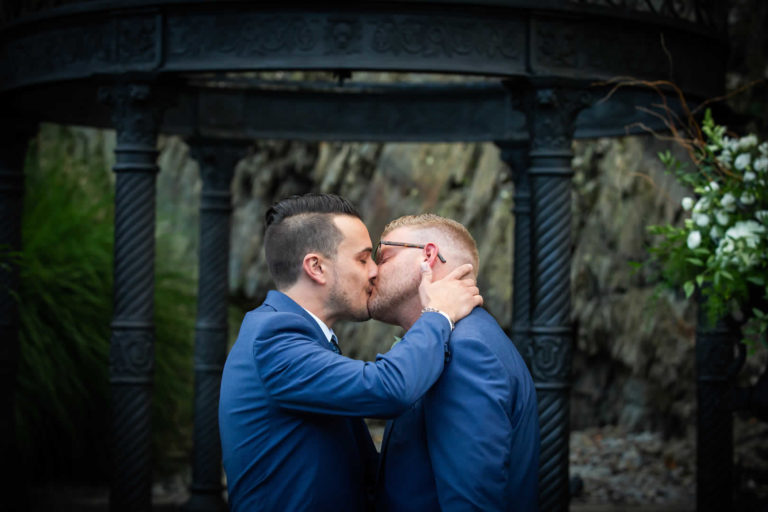 Two grooms share kiss at Terraview ceremony site