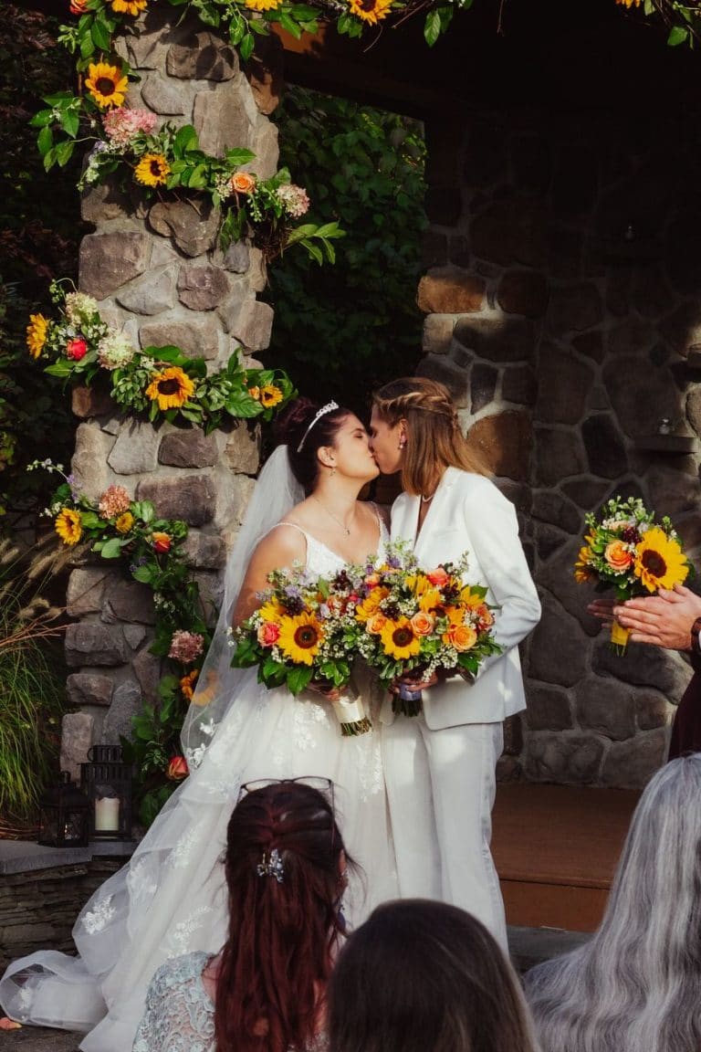 Wedding ceremony - bride and bride - happy wedding couple kissing