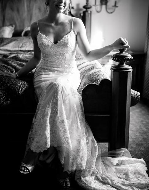 Bride sitting, wearing weddings dress, Black and white