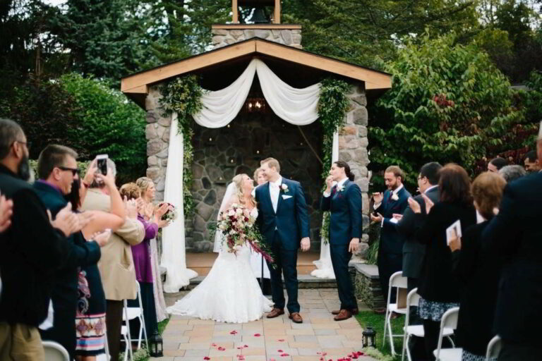 Bride and groom kiss in front of Lawnhaven chapel