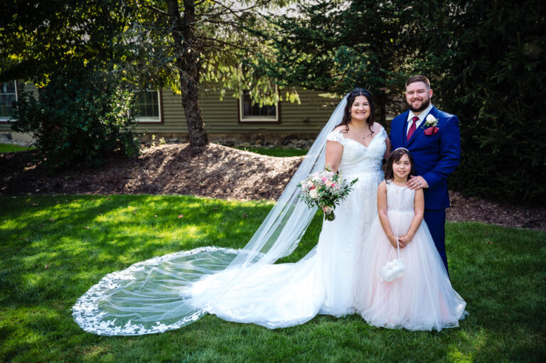 Bride and groom stand with daughter