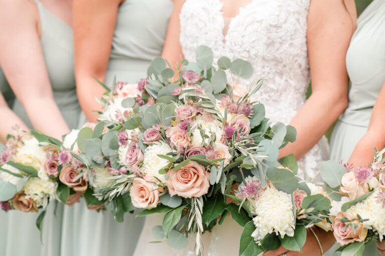 Bride and maids hold pink and green bouquets