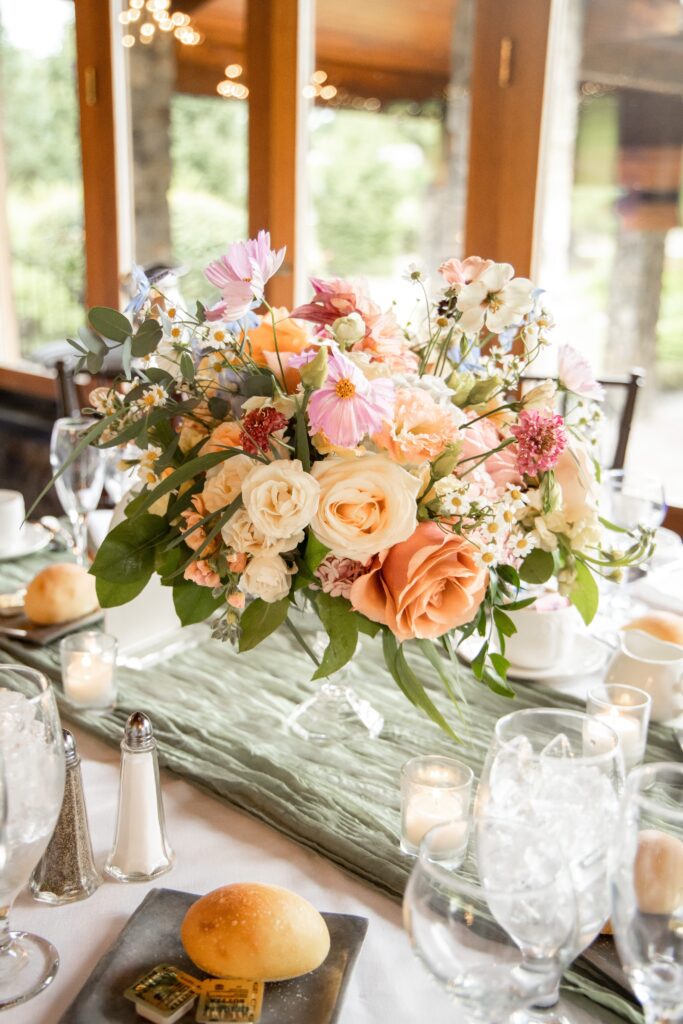 Bright spring florals adorn wedding guest table