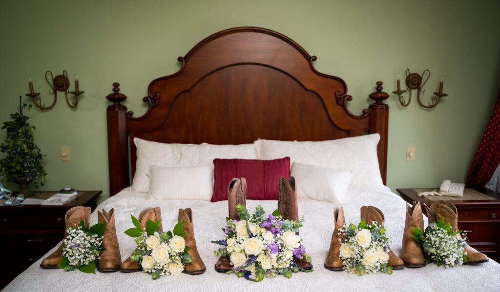 Boots and bridal bouquets adorn queen bed at Stroudsmoor Country Inn