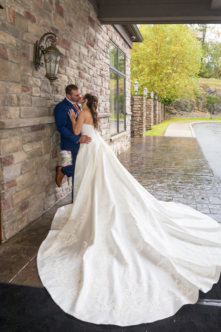 Bride and groom kiss outside Terraview entrance