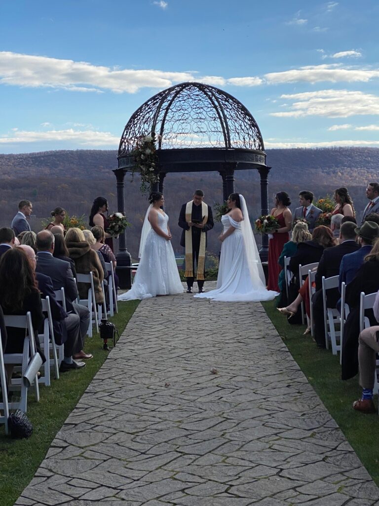 Two brides stand share vows at Ridgecrest ceremony site