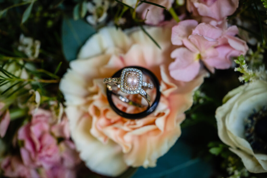 Engagement ring with pinkish hue among florals