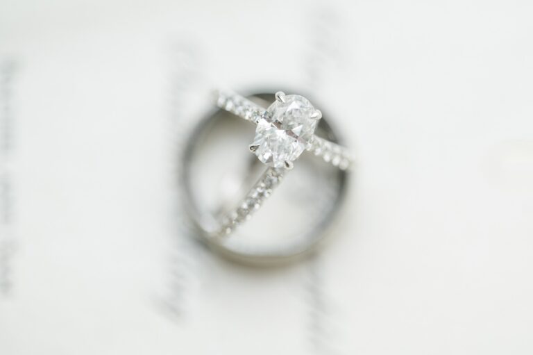 Engagement ring and wedding band against white background