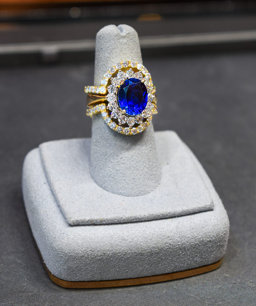 Large lab-created sapphire ring inside Rosé Rosa jewelry case