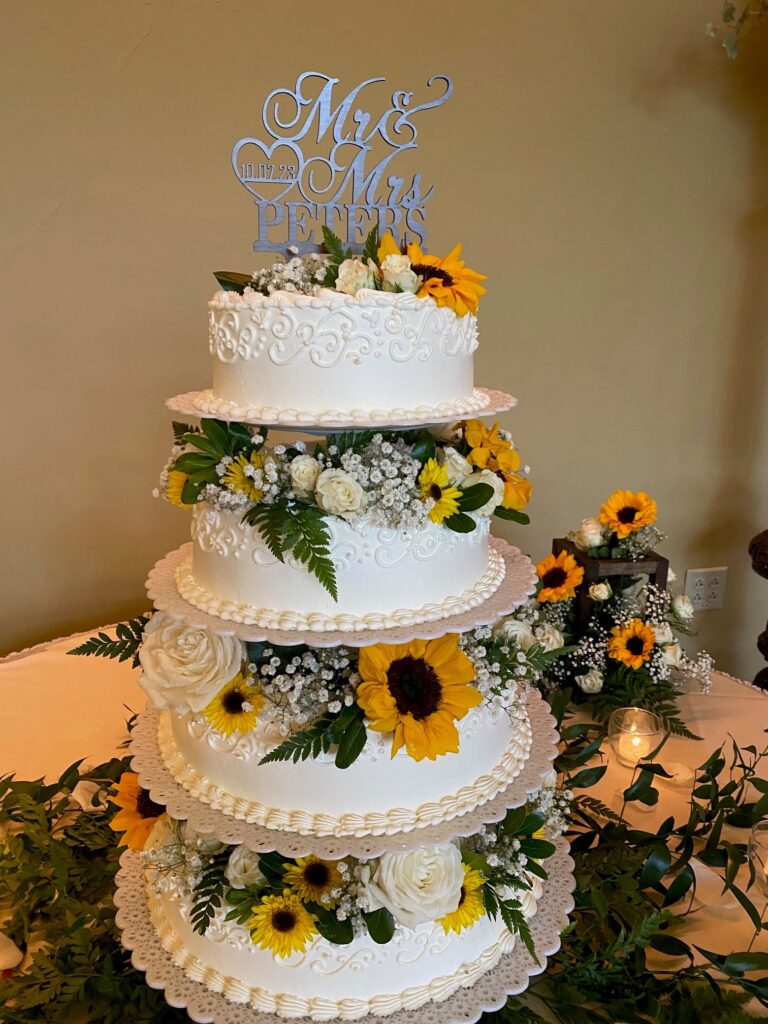 Wedding cake with sunflowers and greens
