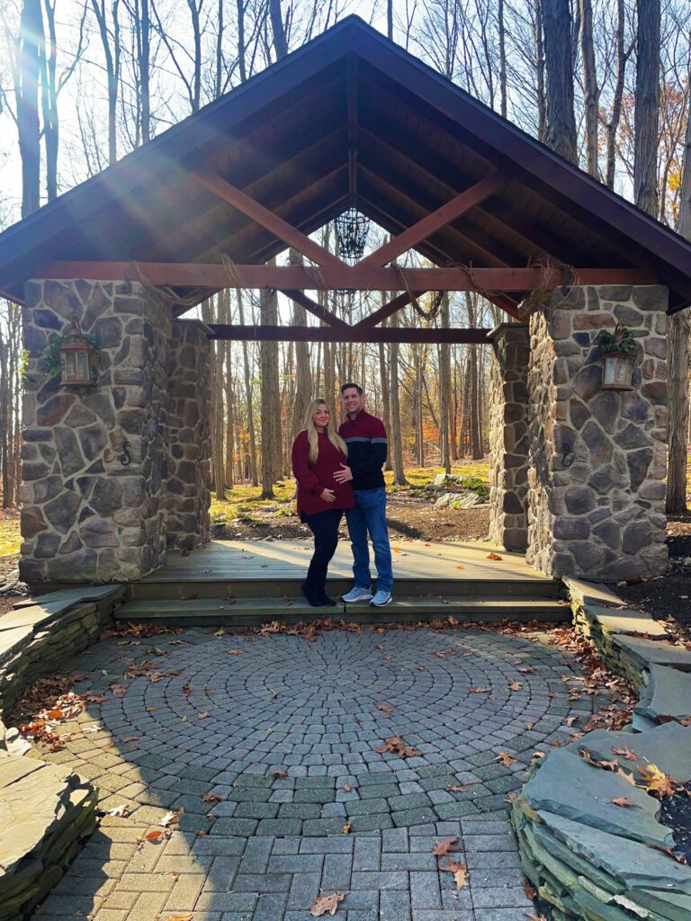 Couple stands beneath Woodsgate's Woodland Chapel
